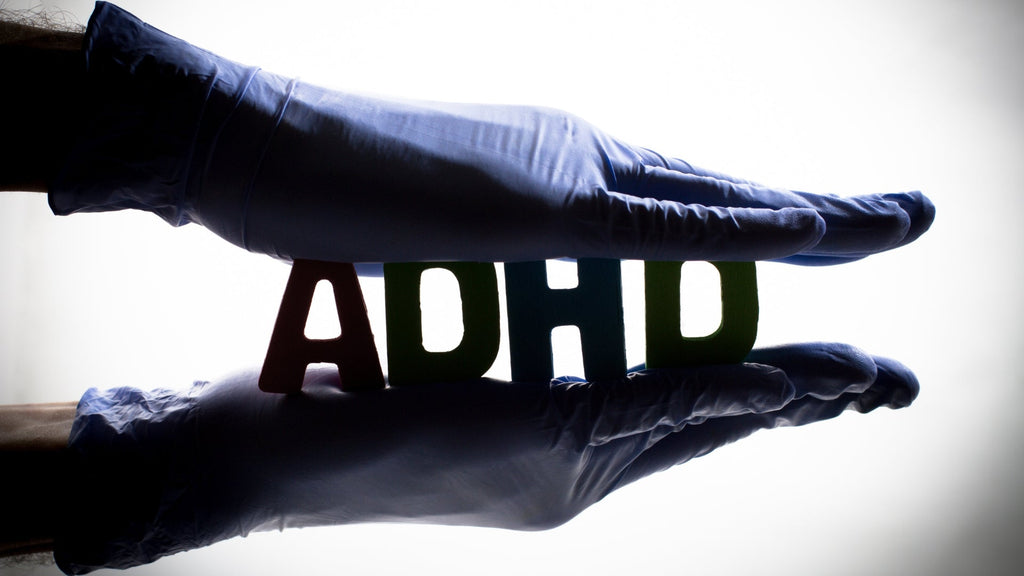 Holding ADHD Letters made from wood with two hands
